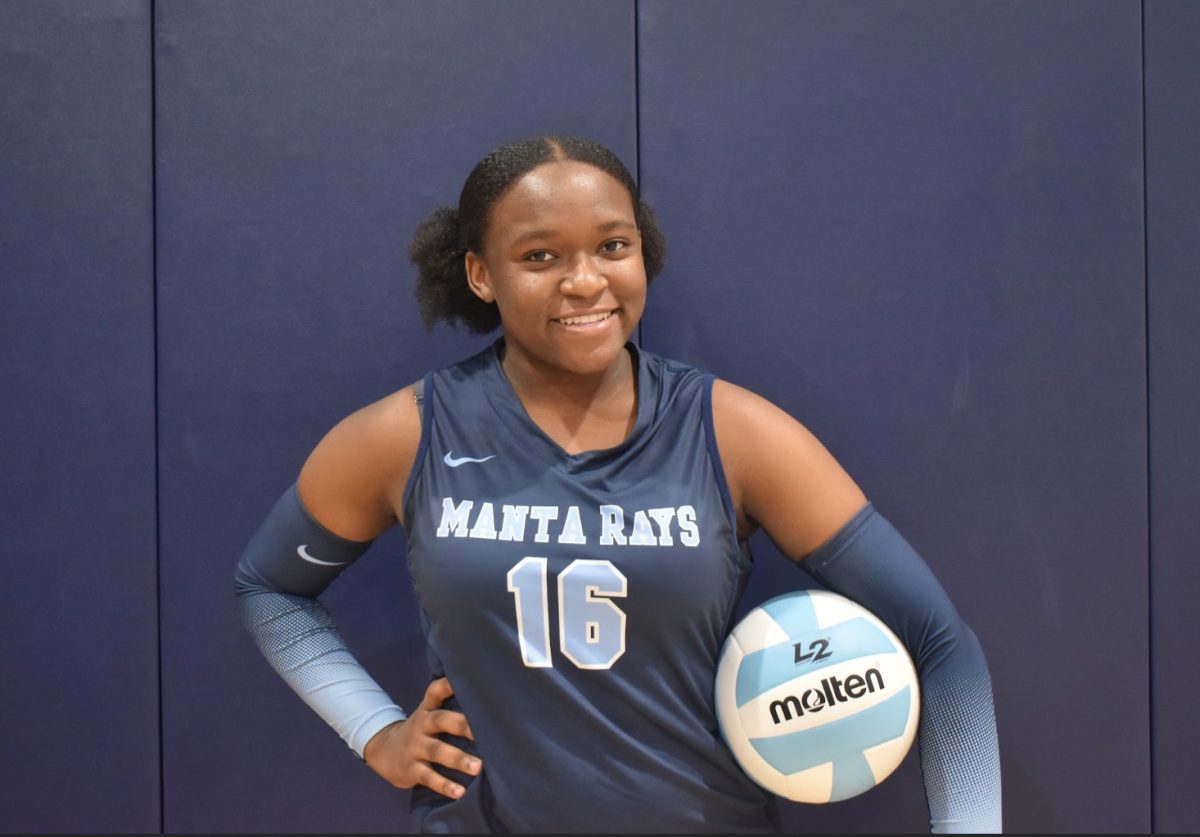 Medney Garraux poses with volleyball at team pictures.